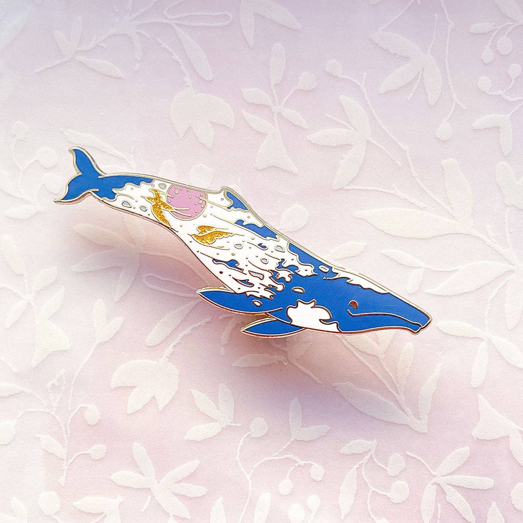 Decorative whale-shaped object on a light pink background