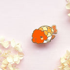 Ranchu Goldfish  pin on a pink background with white flowers