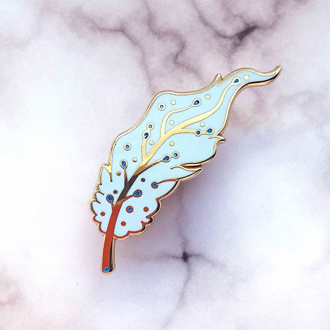 Decorative Pegasus feather pin on a marble background