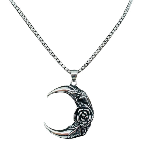 Silver necklace with a crescent moon and rose pendant on a mannequin.