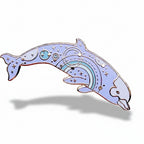 Decorative dolphin pin with celestial design on a white background