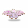 Pink moth-shaped enamel pin on a light background