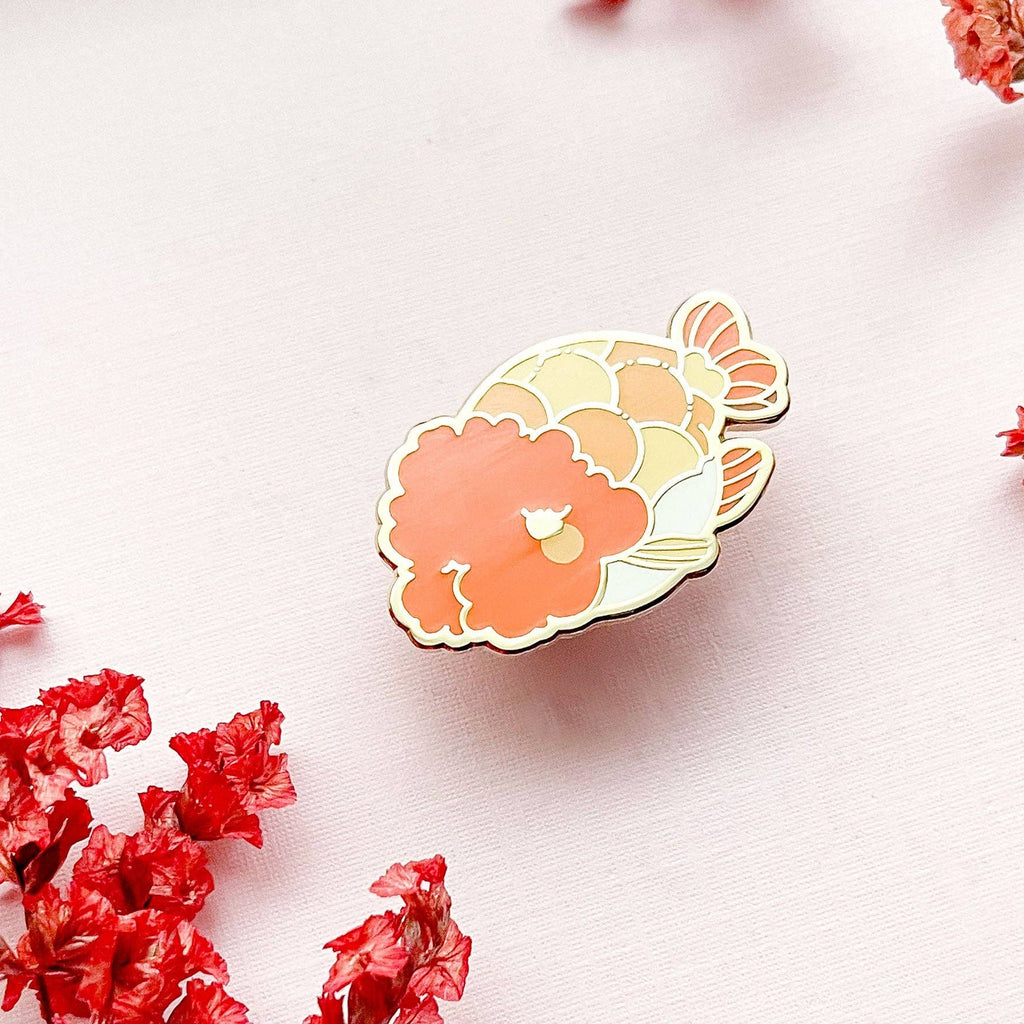 Colorful Ranchu Goldfish with floral design on a light pink background with red flowers.