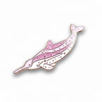 Pink dolphin-shaped pin on a light blue background with yellow flowers
