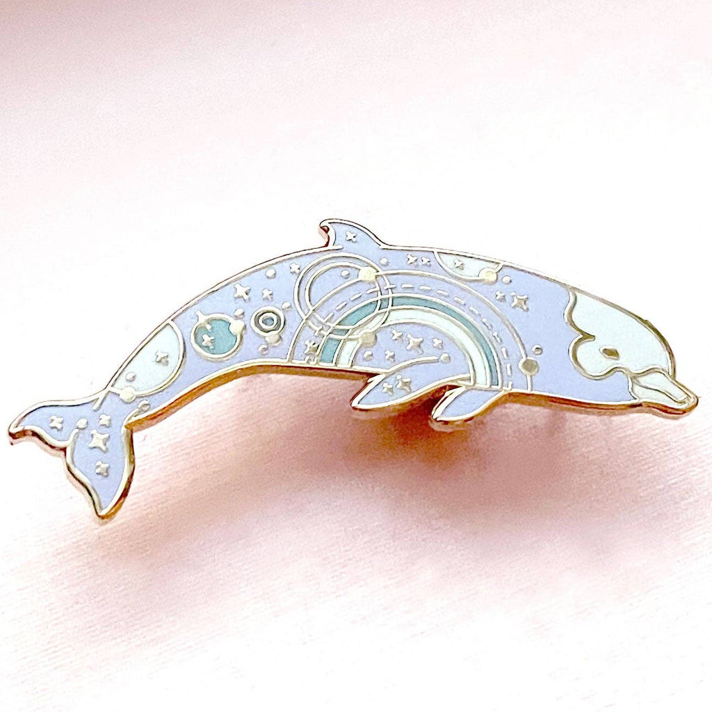 Decorative dolphin-shaped object on a pink background