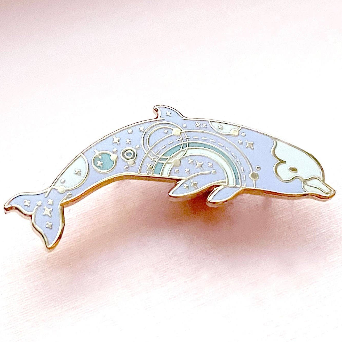 Decorative dolphin-shaped object on a pink background