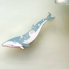 Decorative whale-shaped object on a light background
