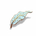 Decorative Pegasus feather pin on a pink background 