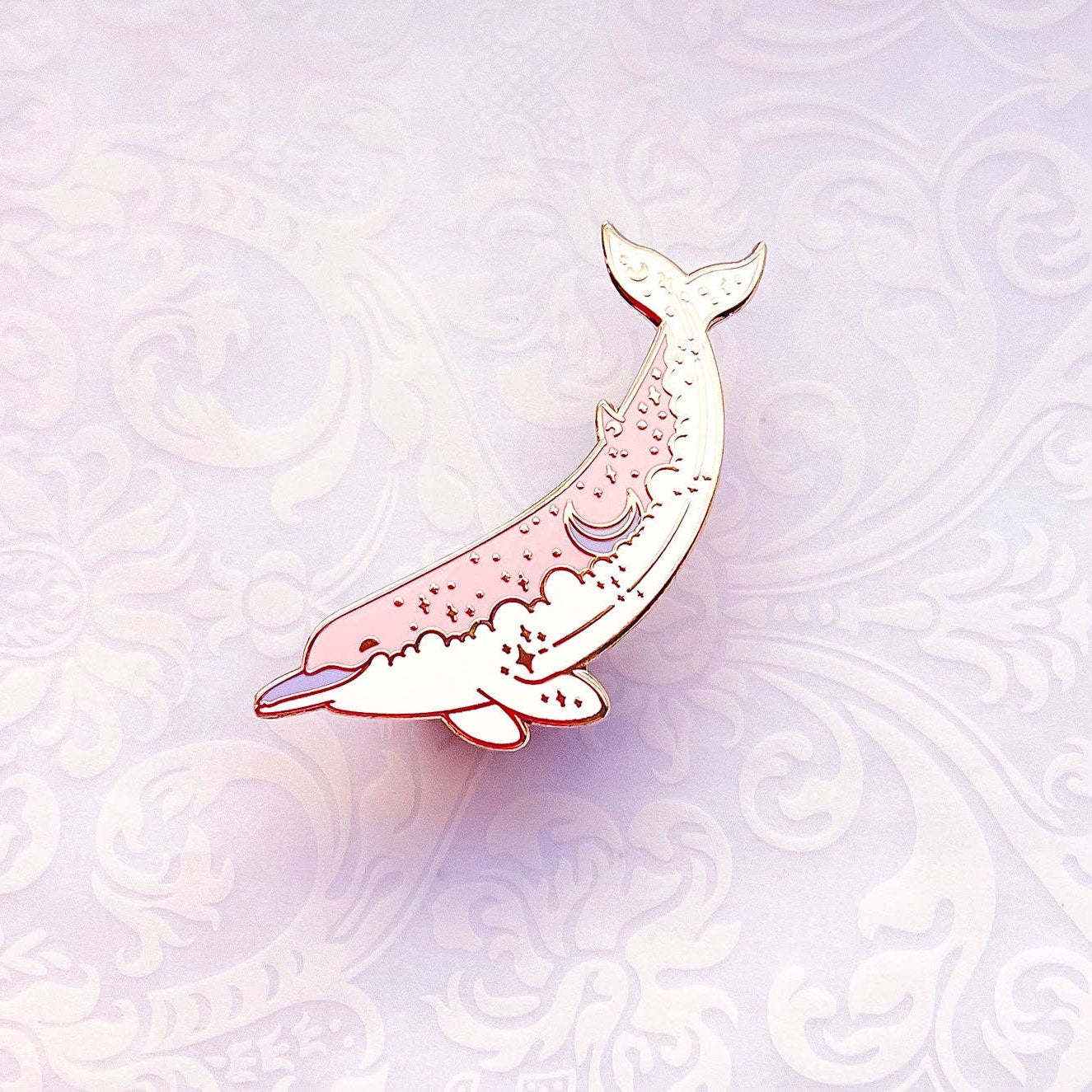 Decorative pink dolphin illustration on a light purple patterned background