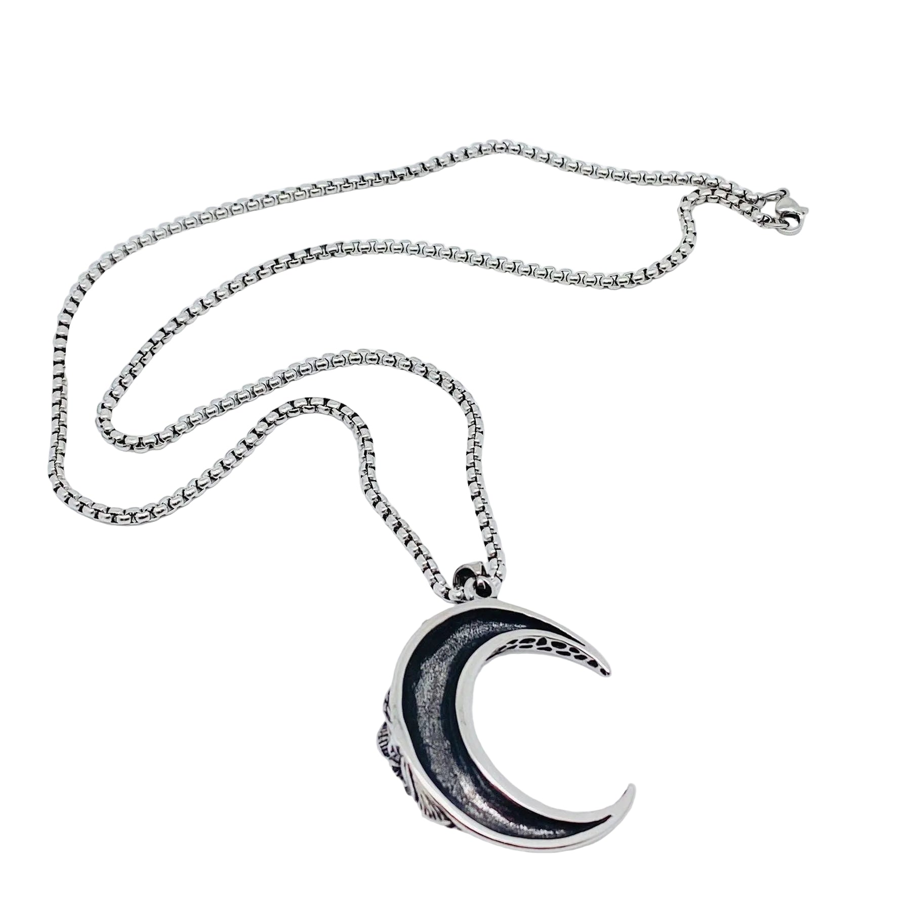 Silver necklace with a crescent moon pendant on a white background
