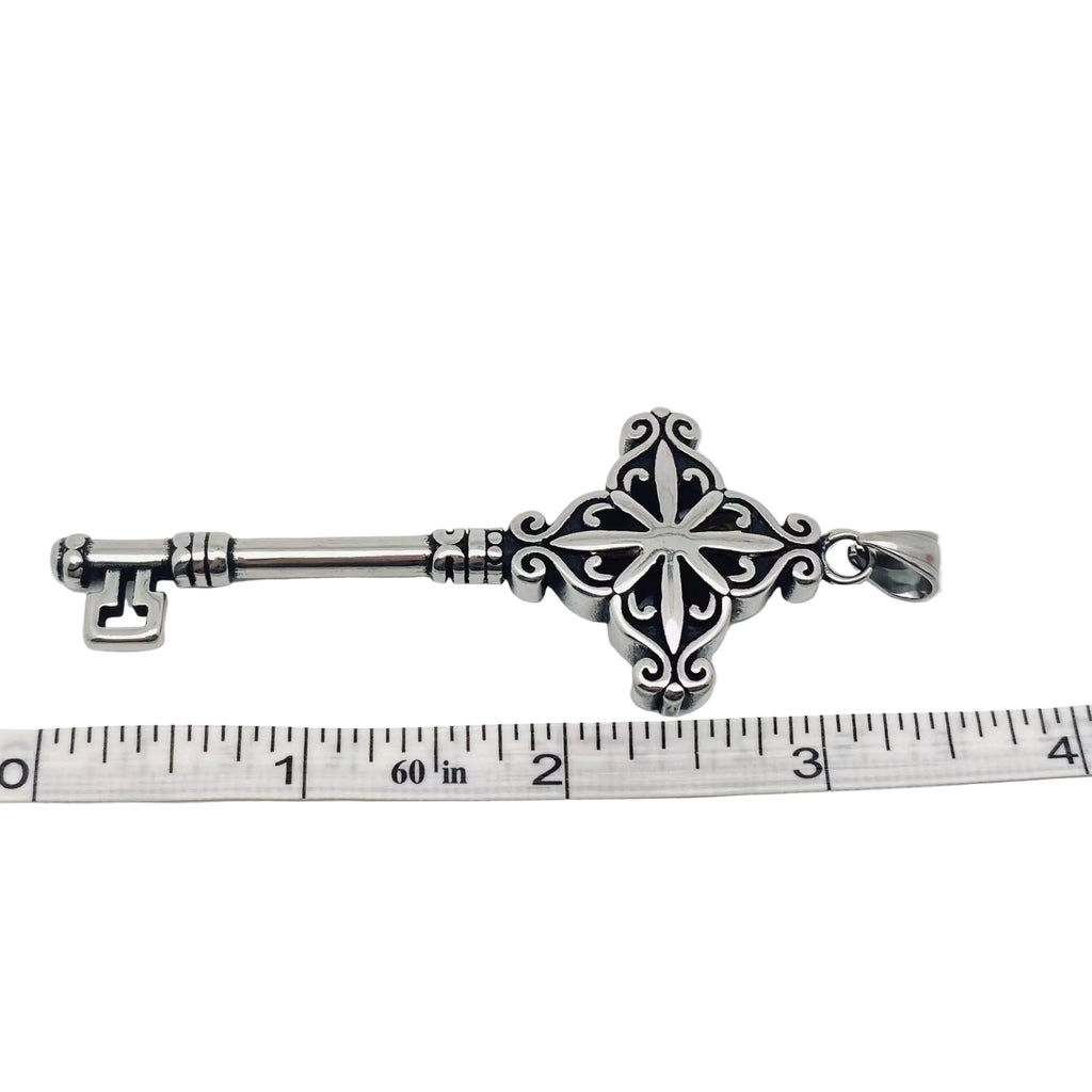 Decorative Stainless Steel 316L Key-Shaped object on a white background with a ruler for scale.