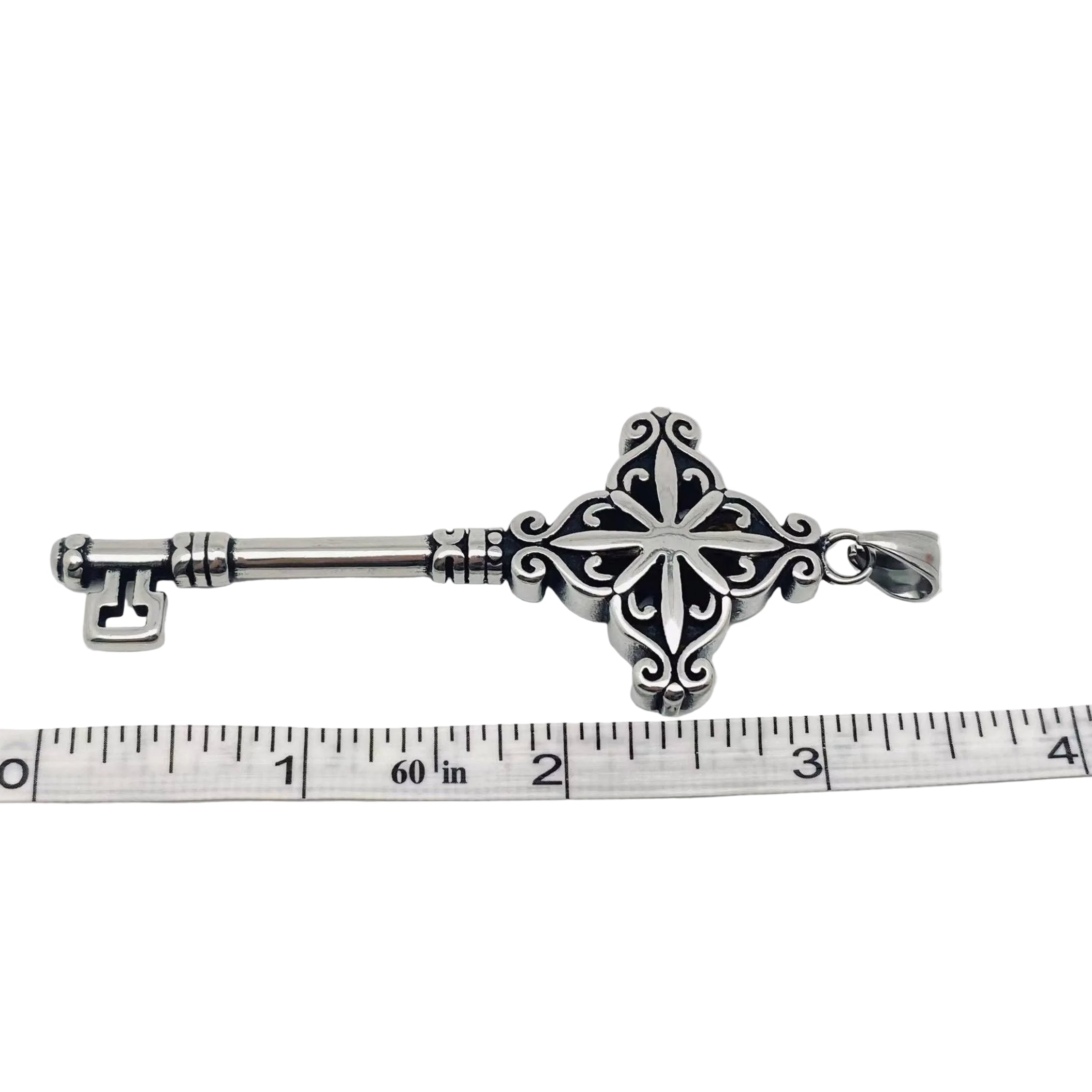 Decorative Stainless Steel 316L Key-Shaped object on a white background with a ruler for scale.