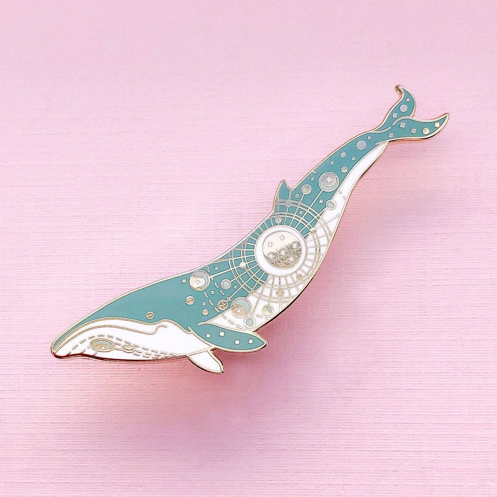 Decorative whale-shaped object on a pink background