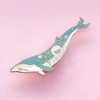 Decorative whale-shaped object on a pink background