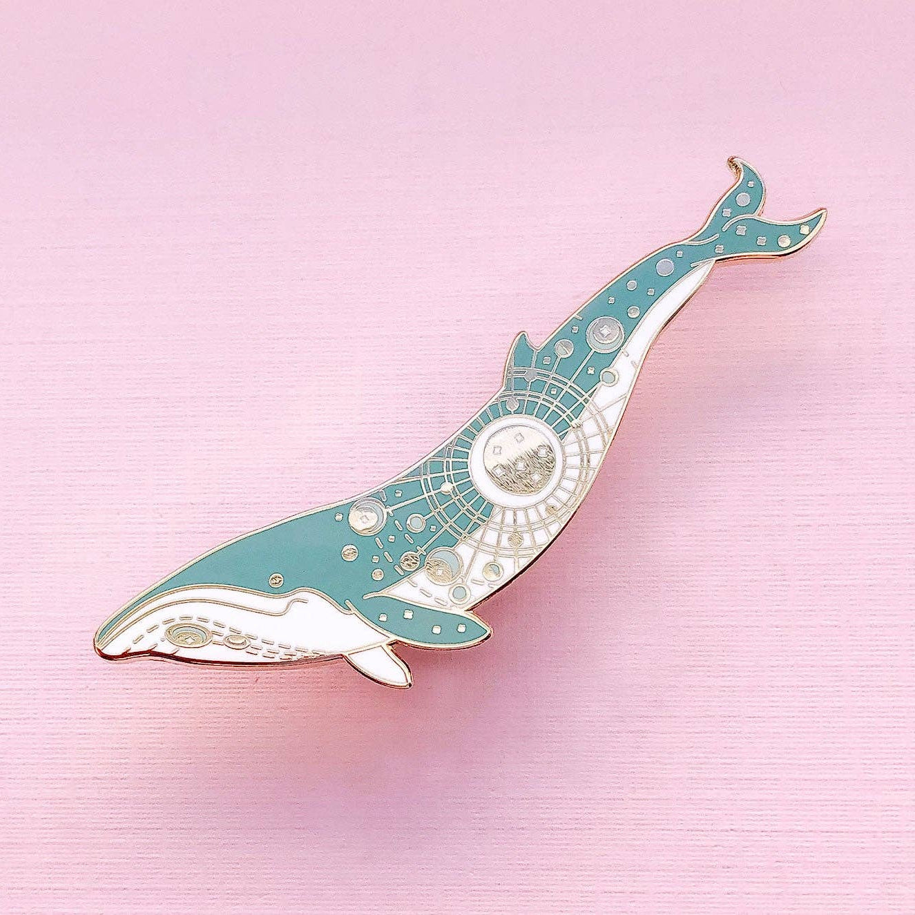 Decorative whale-shaped object on a pink background