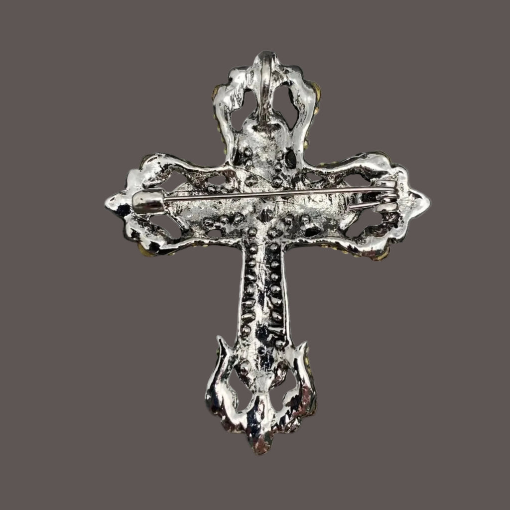 Decorative silver cross on a gray background