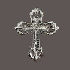 Decorative silver cross on a gray background