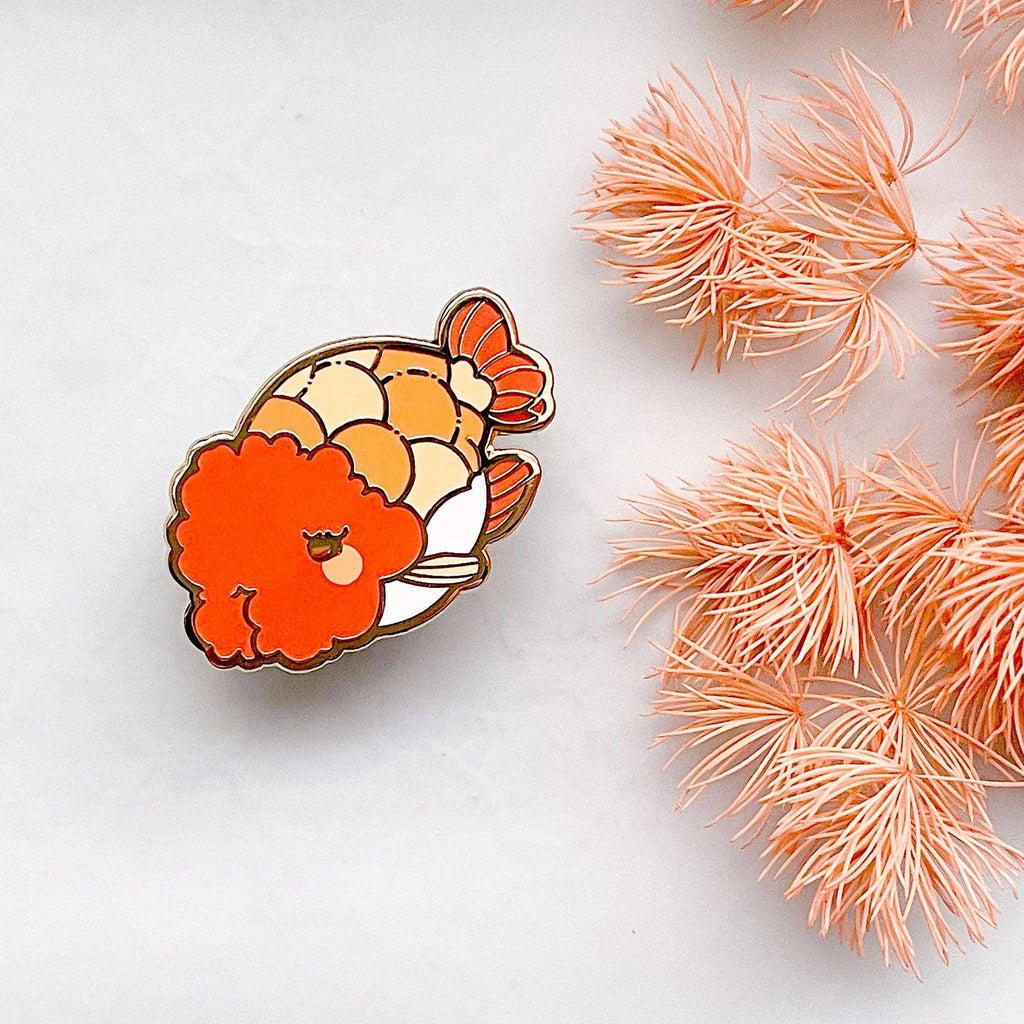 Ranchu Goldfish enamel pin on a white background with pink decorative elements
